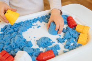 Child Playing With Kinetic Sand